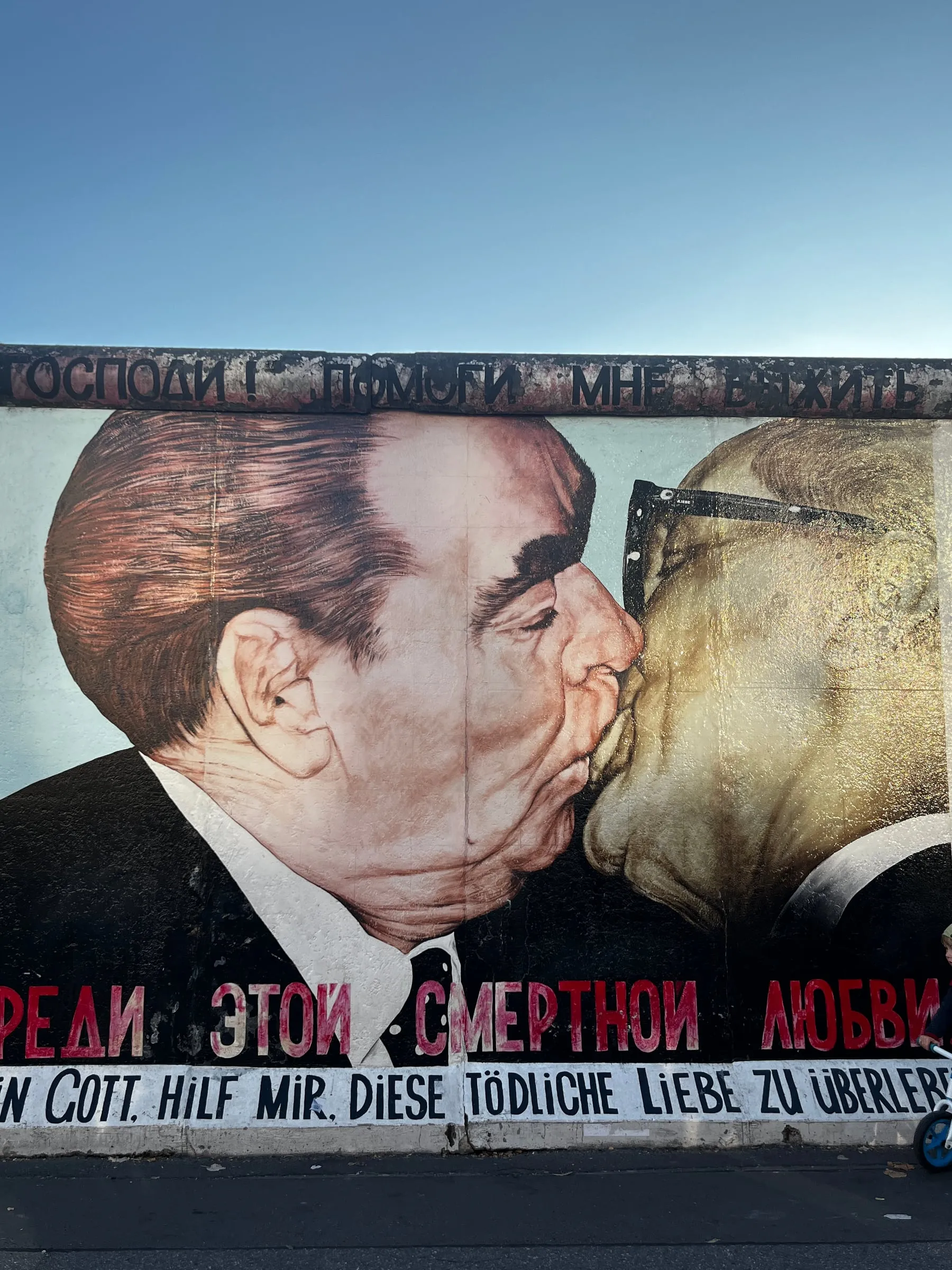 A mural of two men kissing on a surviving section of the Berlin Wall.