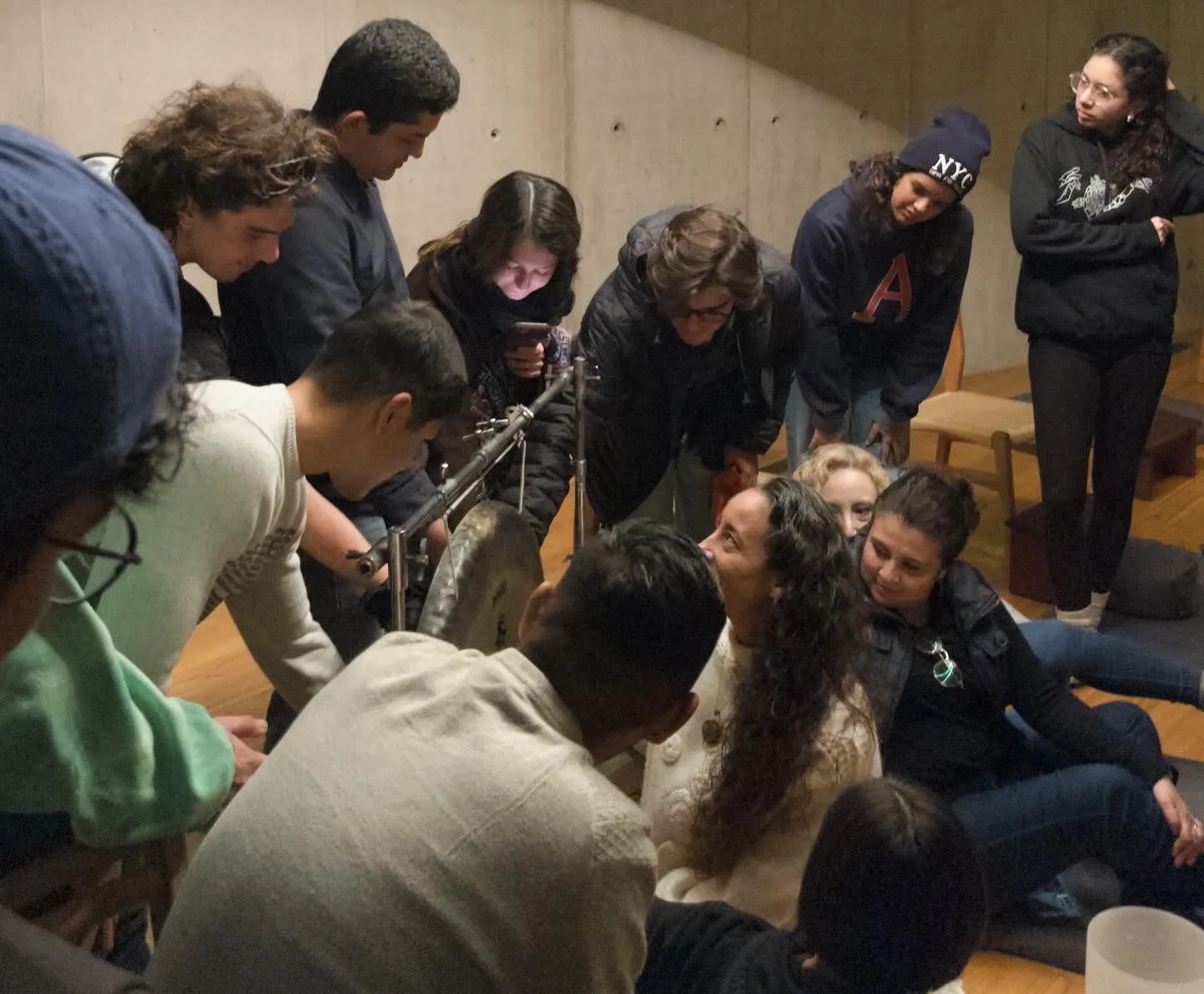A group of people gathered closely together in a room.